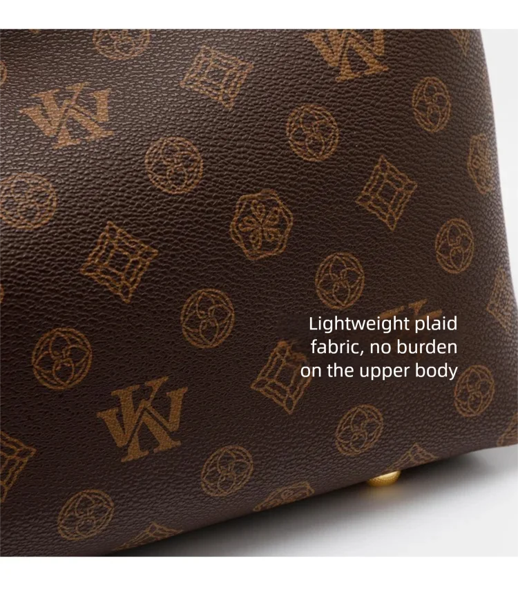 A dark brown canvas tote bag featuring a gold-toned repeating pattern on the fabric.