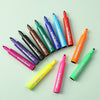 A collection of twelve assorted fruit colored washable scented markers for kids arranged diagonally on a light green surface.