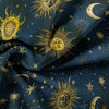 Dark blue fabric featuring gold celestial designs of the sun, moon, and stars.