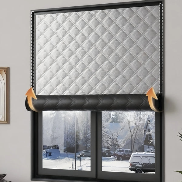 Self-adhesive thermal window film applied to a window, featuring a diamond-patterned silver texture for winter insulation.