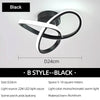 Black modern clover LED ceiling light fixture shown against a white wall.