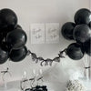 Black balloons tied with black ribbon forming a garland display