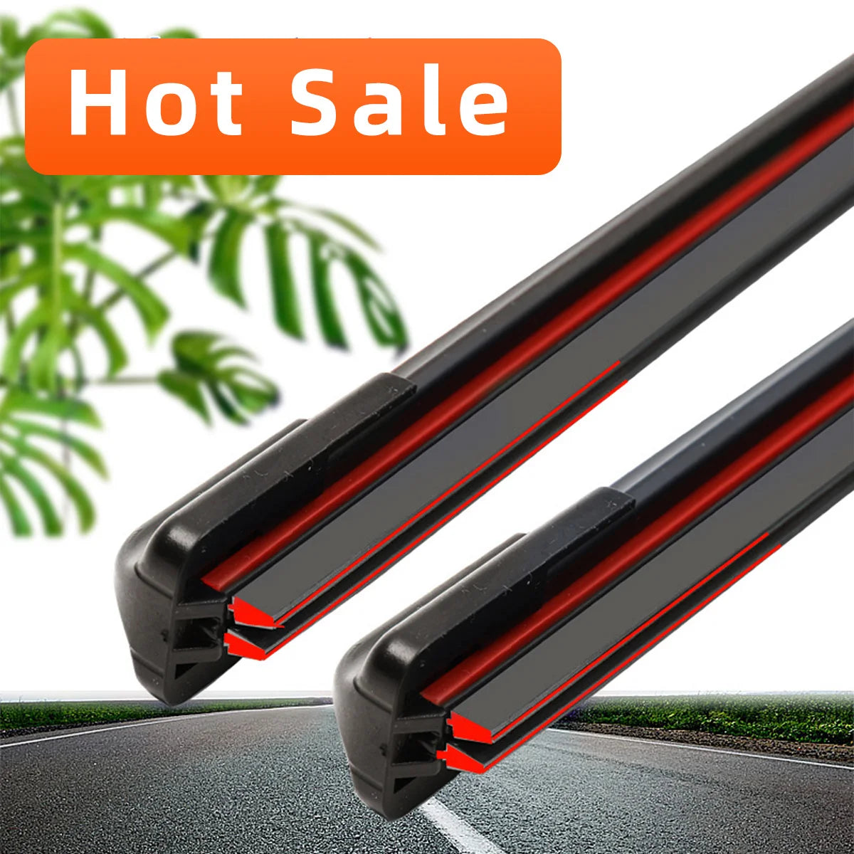 A close-up view of two black frameless wiper blades with dual red rubber edges on a car windshield.