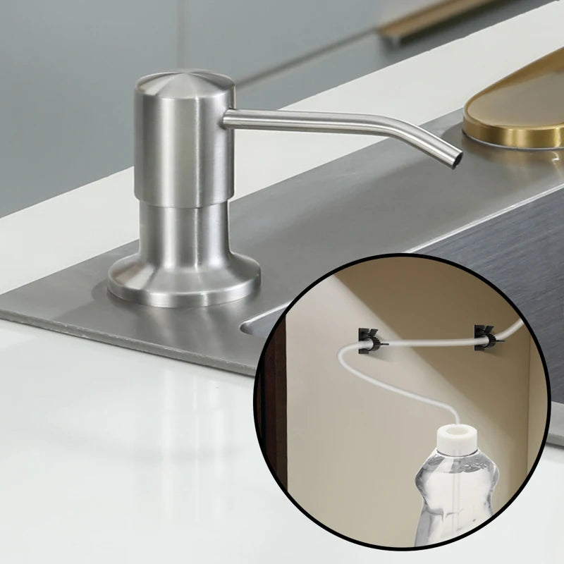 Stainless steel countertop liquid soap dispenser with an extension tube on a white surface.