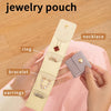 A hand holds a beige PU leather jewelry pouch displaying four compartments for storing necklaces, rings, bracelets, and earri