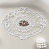 Elegant oval white lace embroidered placemat with a floral design