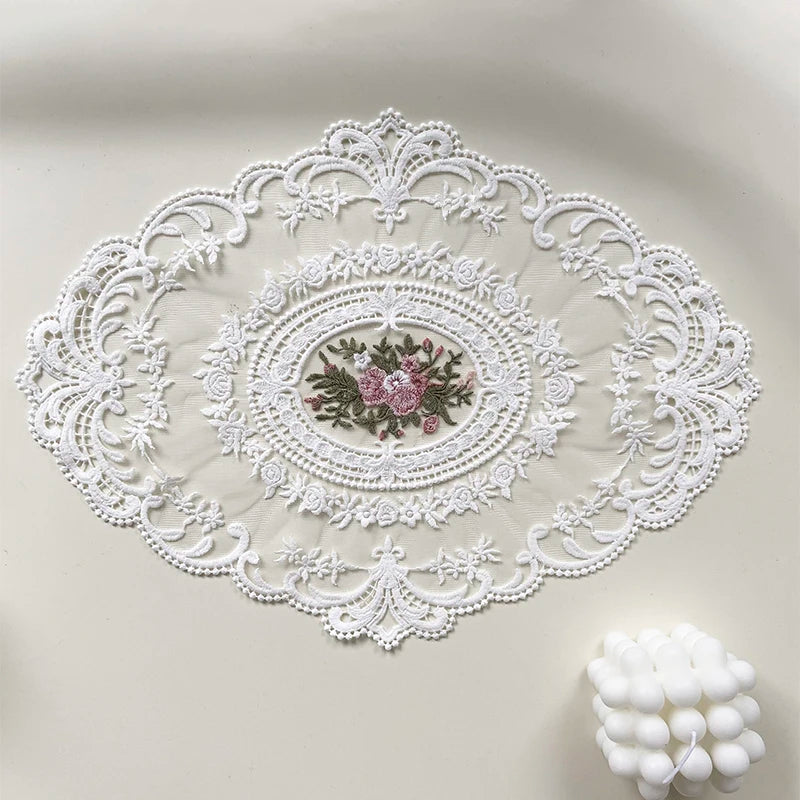 Elegant oval white lace embroidered placemat with a floral design