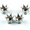 A set of four silver universal crown valve caps with decorative points.