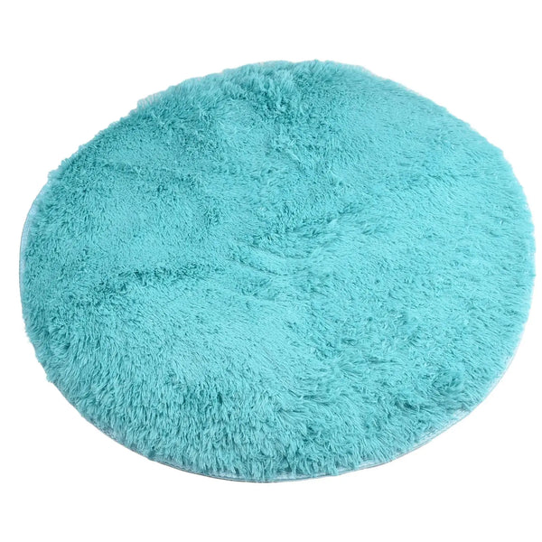 A round, light turquoise shag area rug with a dense, fluffy texture and non-slip backing.