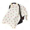 A white breathable stroller cover with pink floral patterns and a black strap.