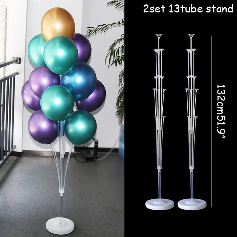 A set of two 13-tube clear plastic balloon column stands with gold and iridescent balloons for party decor.