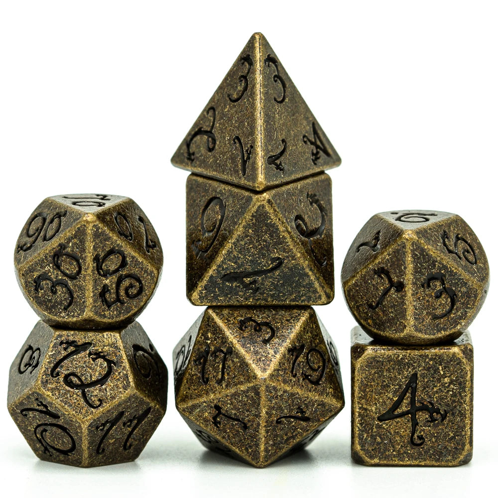 A set of seven metal polyhedral dice with a dragon font design arranged in a pyramid and surrounding cubes.