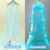Light blue sheer fabric mosquito net with LED lights draped like a bed curtain