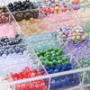 A collection of mixed acrylic beads in various colors and styles displayed in a transparent box for jewelry making