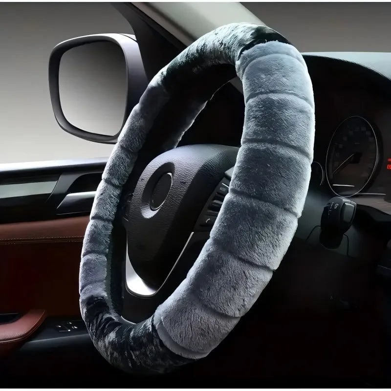 A cozy cartoon plush steering wheel cover wrapped in gray fur is shown on a car's interior dashboard.