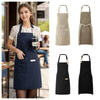 A set of waterproof canvas chef aprons in beige and black shown on a model.