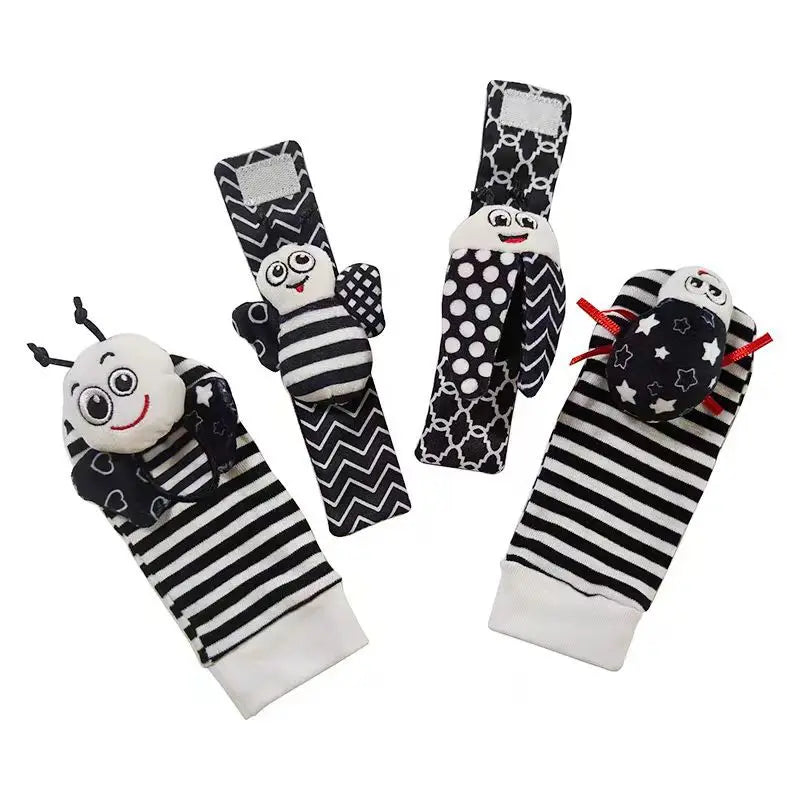 A set of black and white baby wrist and foot rattles sensory toys featuring animal designs.