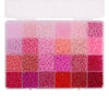 A storage box filled with various shades of pink, red, and purple acrylic rice beads in a 24-grid arrangement.