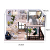 A detailed miniature wooden dollhouse building kit featuring furniture and interior decor.