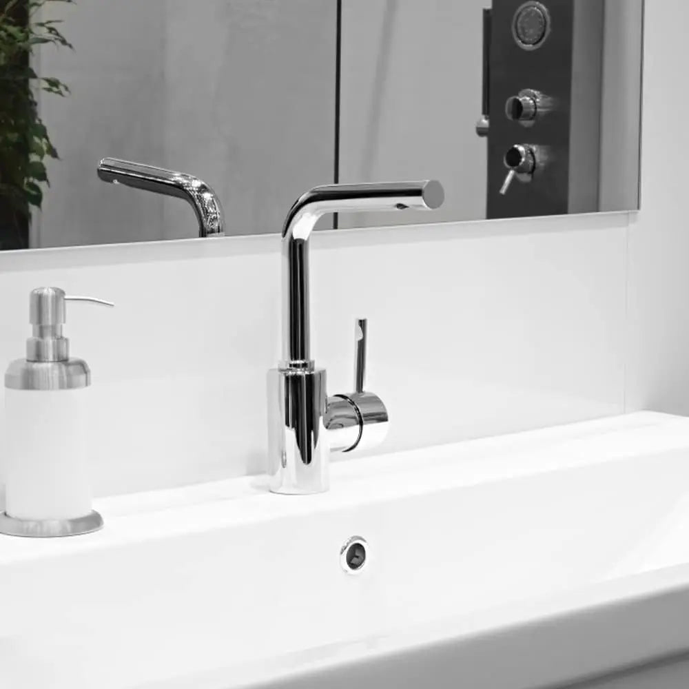 A close-up of a modern chrome faucet mounted on a white bathroom sink.