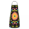 A black apron with a vibrant Mexican floral pattern featuring yellow, pink, and blue flowers.