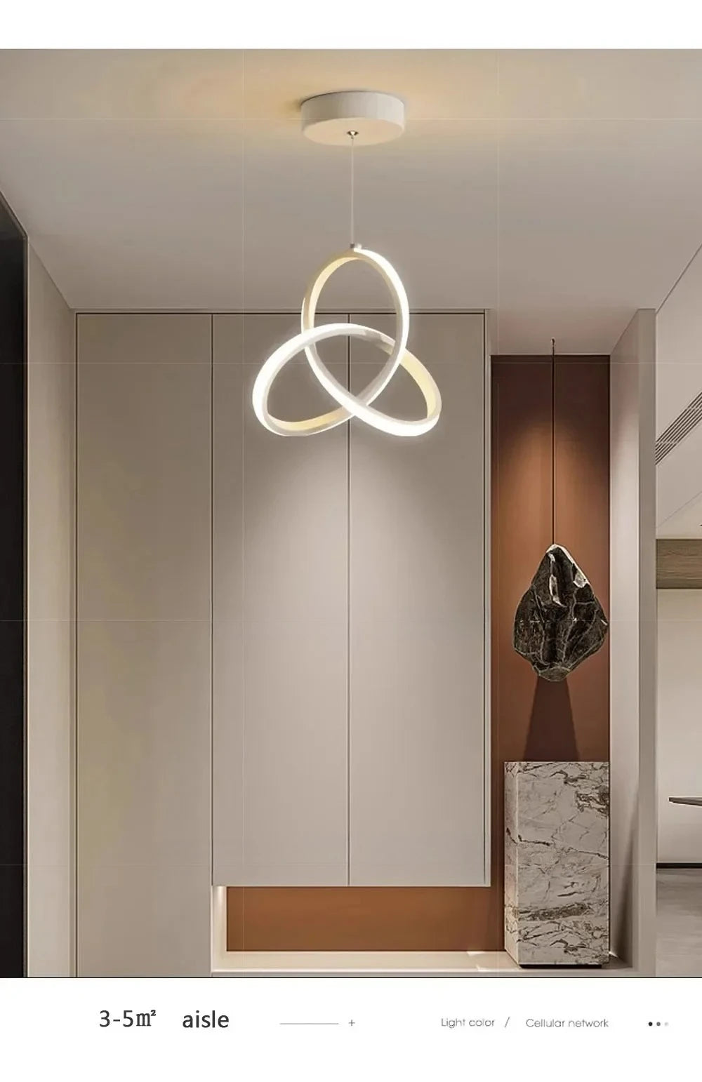 A modern pendant light with a gold-toned, circular ring design hangs in a minimalist interior space.