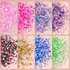 A collection of colorful flatback pearls and rhinestones in various shades and sizes displayed in individual square compartme
