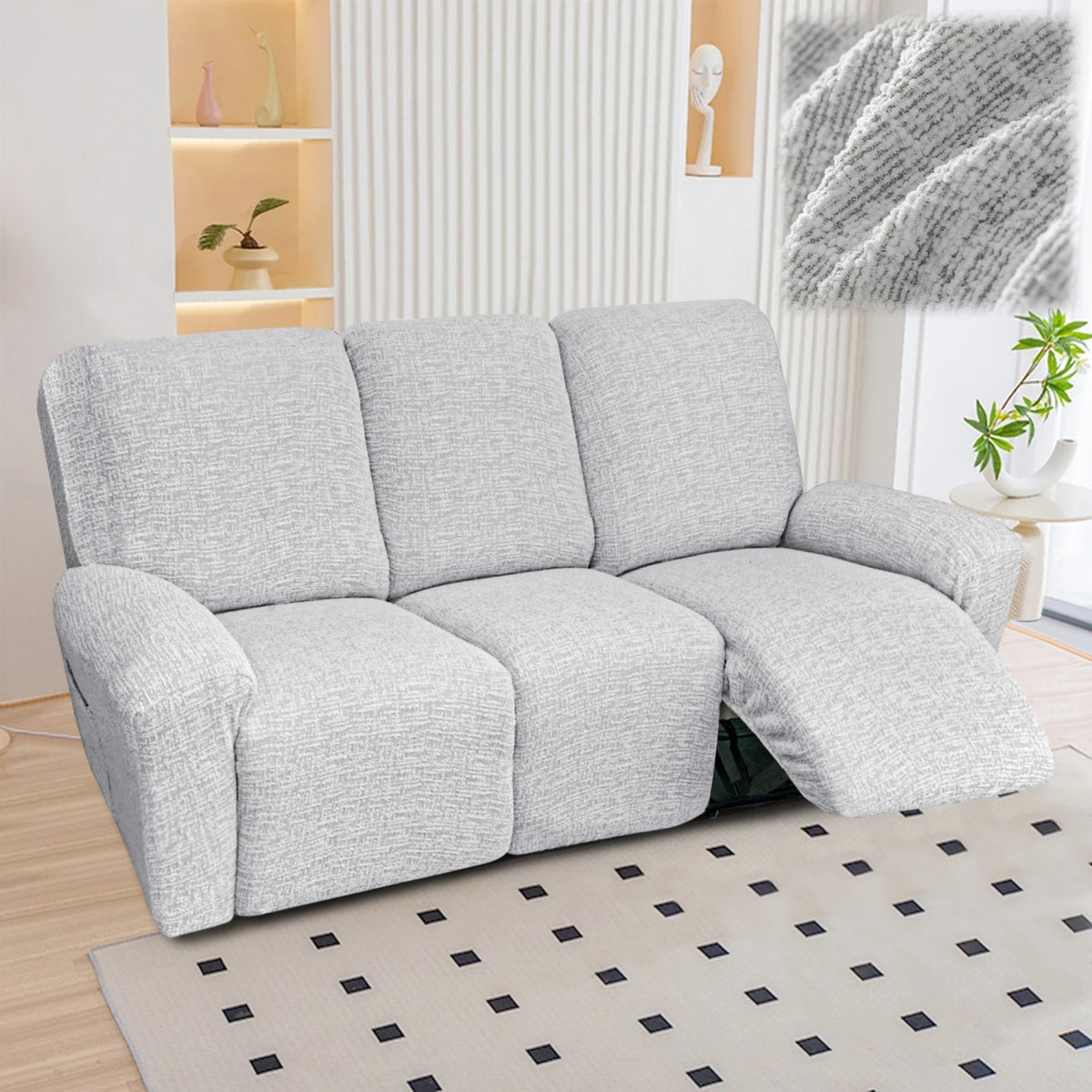 A light gray heavy-duty linen stretch sofa cover for recliners displayed on a floor.