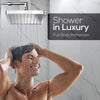 A man is enjoying a shower from a 6-inch high-pressure rainfall shower head in a luxurious bathroom setting.