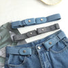 A close-up of a blue stretch elastic belt with dark gray buckle and a matching belt worn on denim jeans.