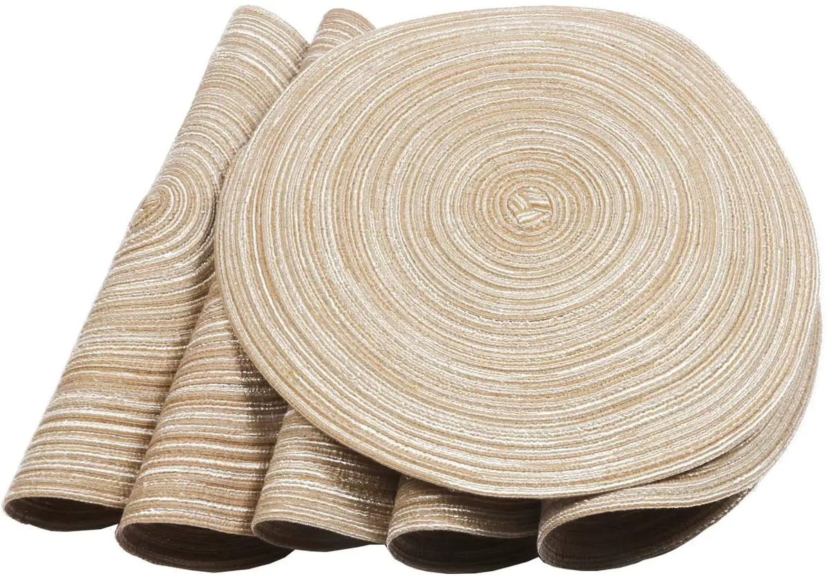 A set of six beige braided round placemats rolled up and displayed on a surface.