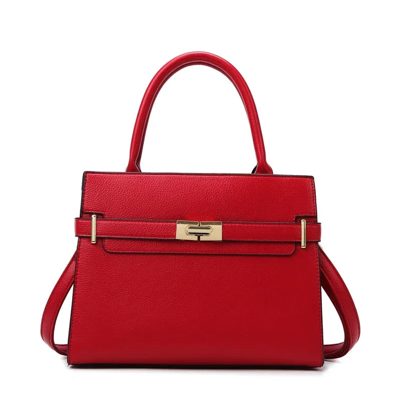A red leather handbag with a gold-toned clasp and matching coin purse.