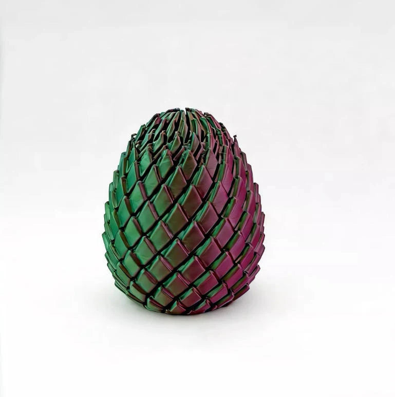 A close-up of a twisted, textured fidget egg stress relief toy in shades of green and magenta.