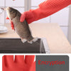 A hand wearing an orange silicone anti-skid glove is holding a small fish on a wooden surface.