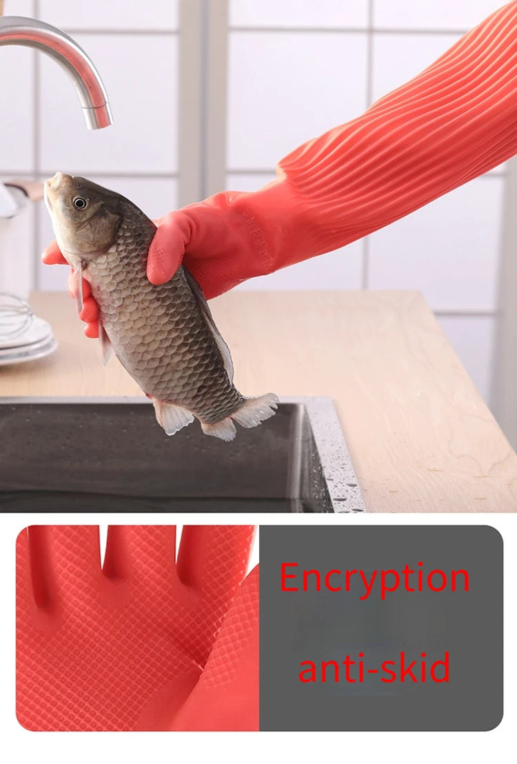 A hand wearing an orange silicone anti-skid glove is holding a small fish on a wooden surface.