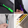 Close-up shots of colorful plastic zipper pulls in green, purple, and yellow being used on a black fabric item.