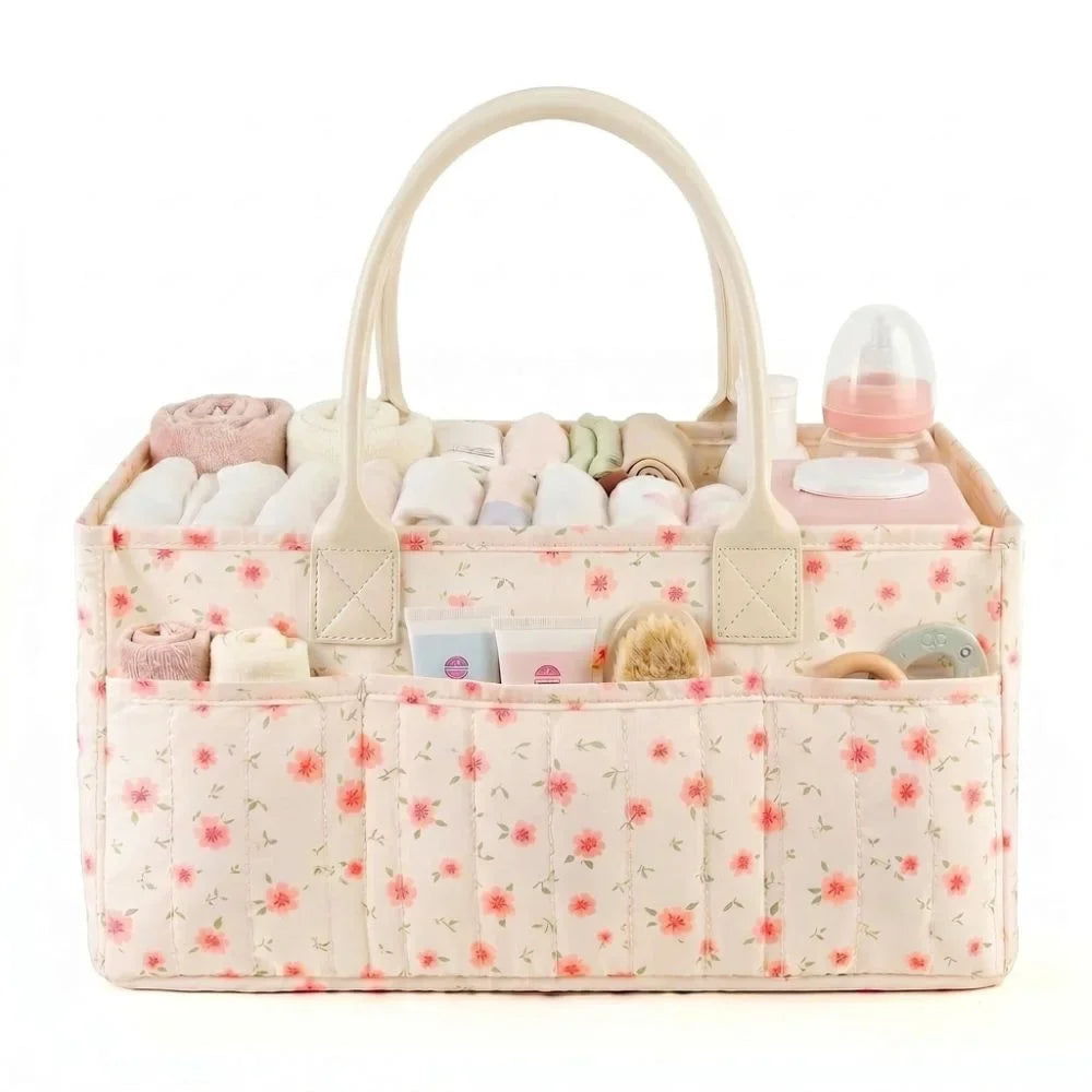 A light pink floral diaper organizer bag with multiple compartments and a curved handle.