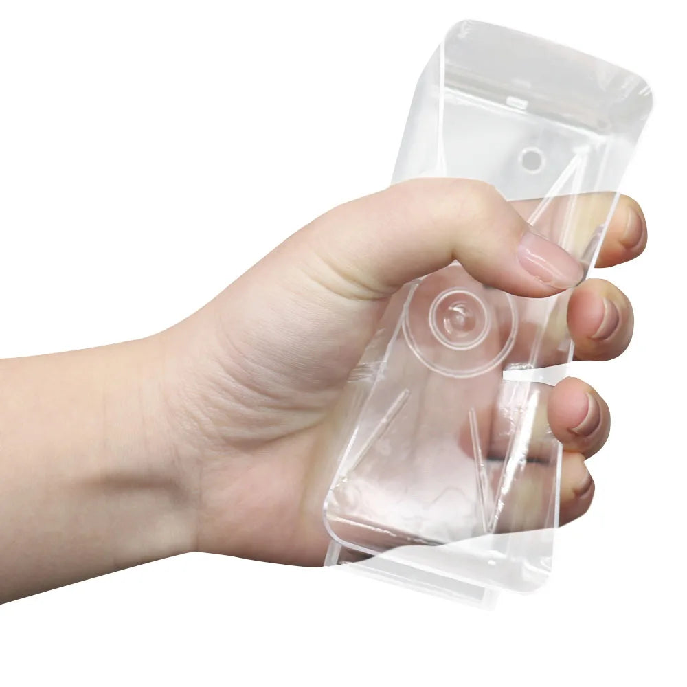 A hand is holding a clear plastic wall-mounted parts organizer with drawers.