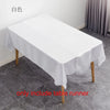White satin table runner displayed on a wooden table, ready for events.