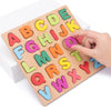 A wooden alphabet puzzle board showing colorful letters A through Z for toddlers