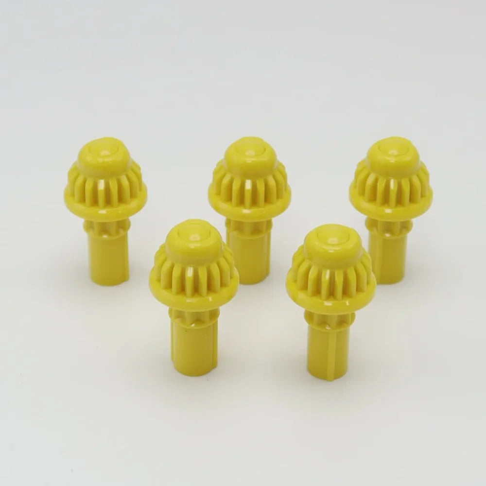 A set of five yellow replacement drivers for a Battling Top, used to fix or replace the top mechanism.