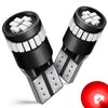 A pair of black LED bulbs with white chips and contacts are shown, along with a red light bulb.