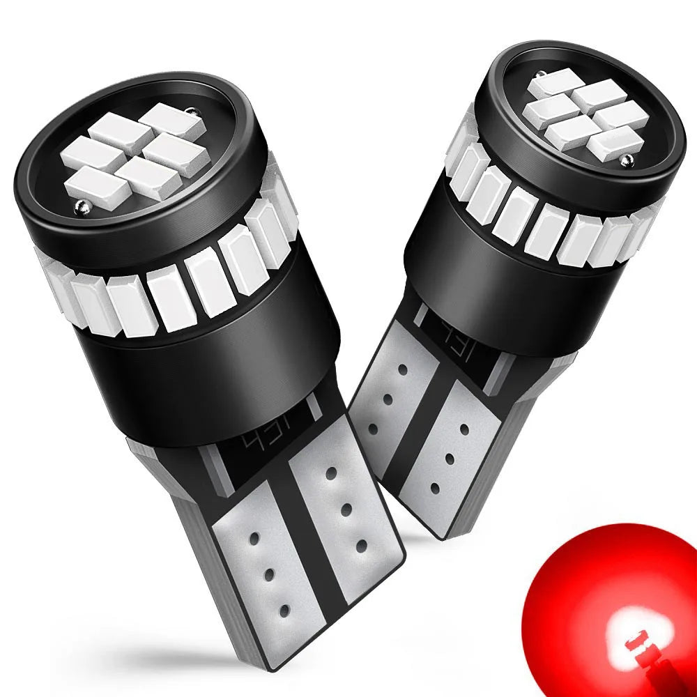 A pair of black LED bulbs with white chips and contacts are shown, along with a red light bulb.