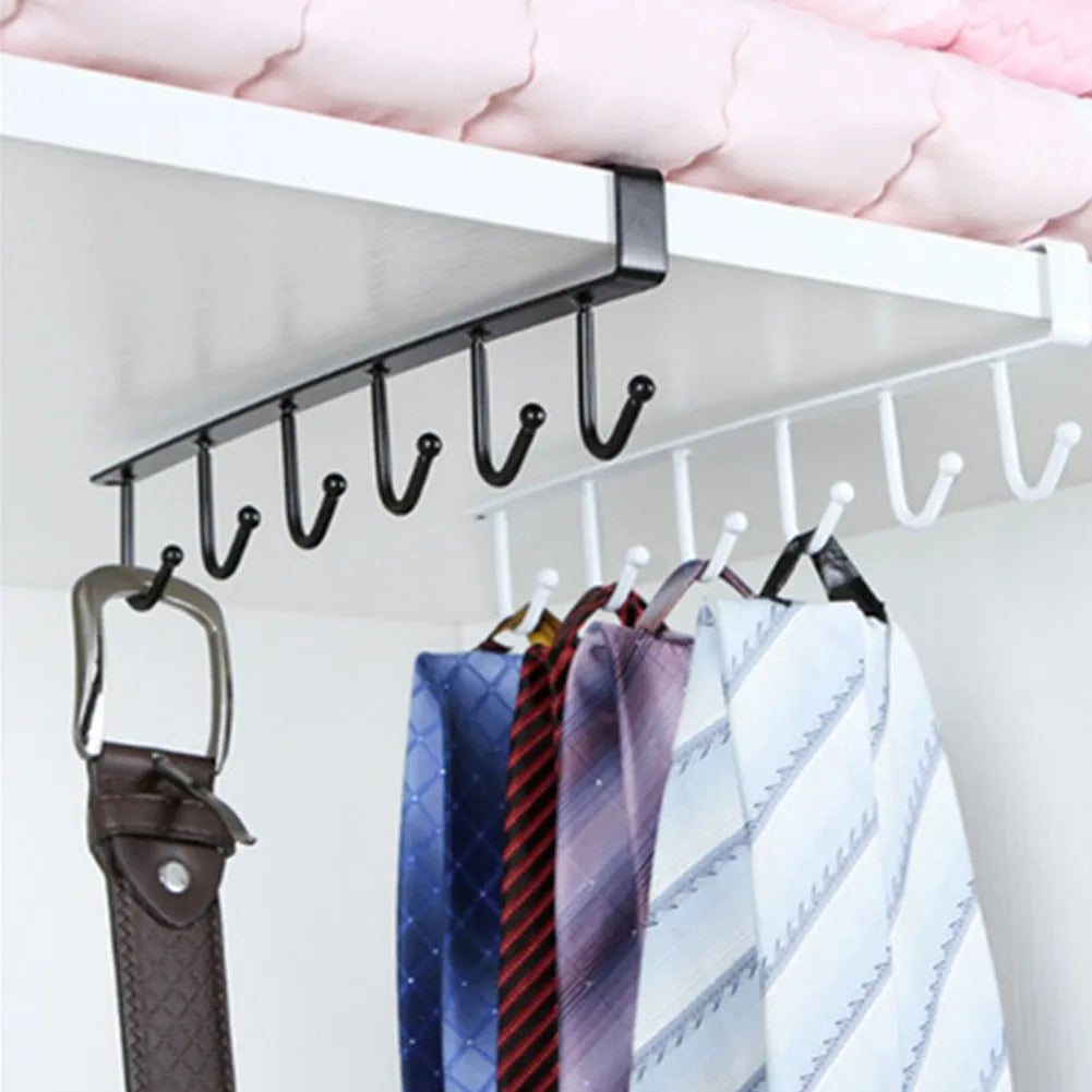 A black under-shelf cup and utensil holder with six hooks mounted on a white shelf.