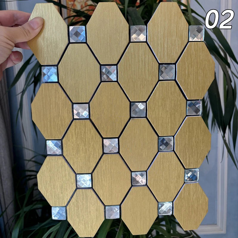 A square mosaic of light wood-toned tiles with silver and blue accents, held by a hand against green foliage.