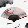 A folding fan with pink and white stripes featuring red floral designs on the surface.