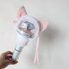 A pink plush cover for a SEVENTEEN official light stick is shown being held by a hand.