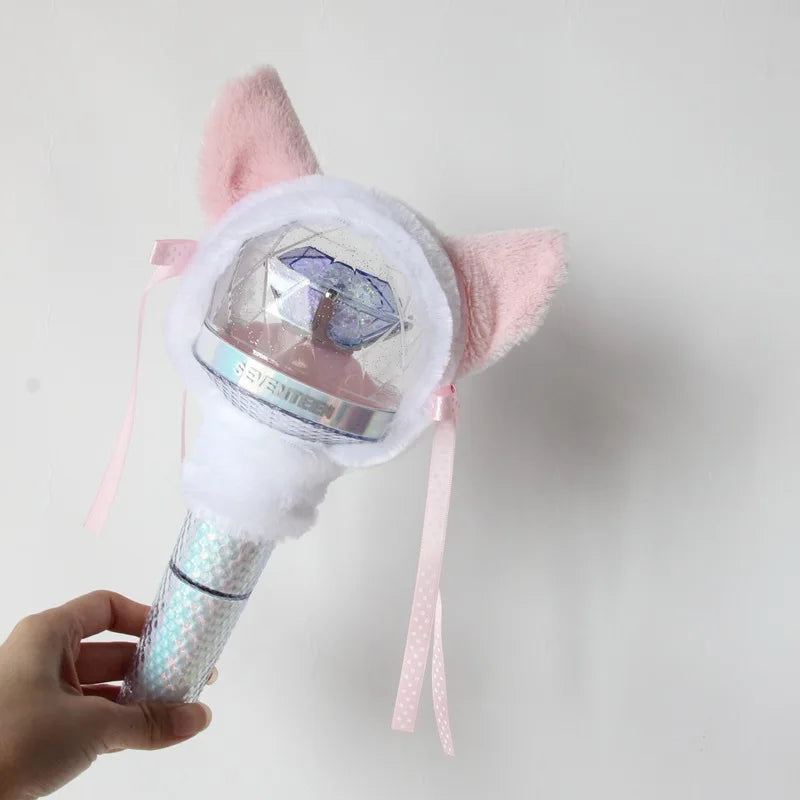 A pink plush cover for a SEVENTEEN official light stick is shown being held by a hand.