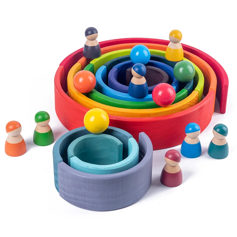 A colorful wooden rainbow stacking block set with various colored spheres and wooden figures.