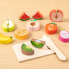 A set of wooden pretend play cutting fruit and vegetable toys including an apple, watermelon, lemon, and kiwi slices.
